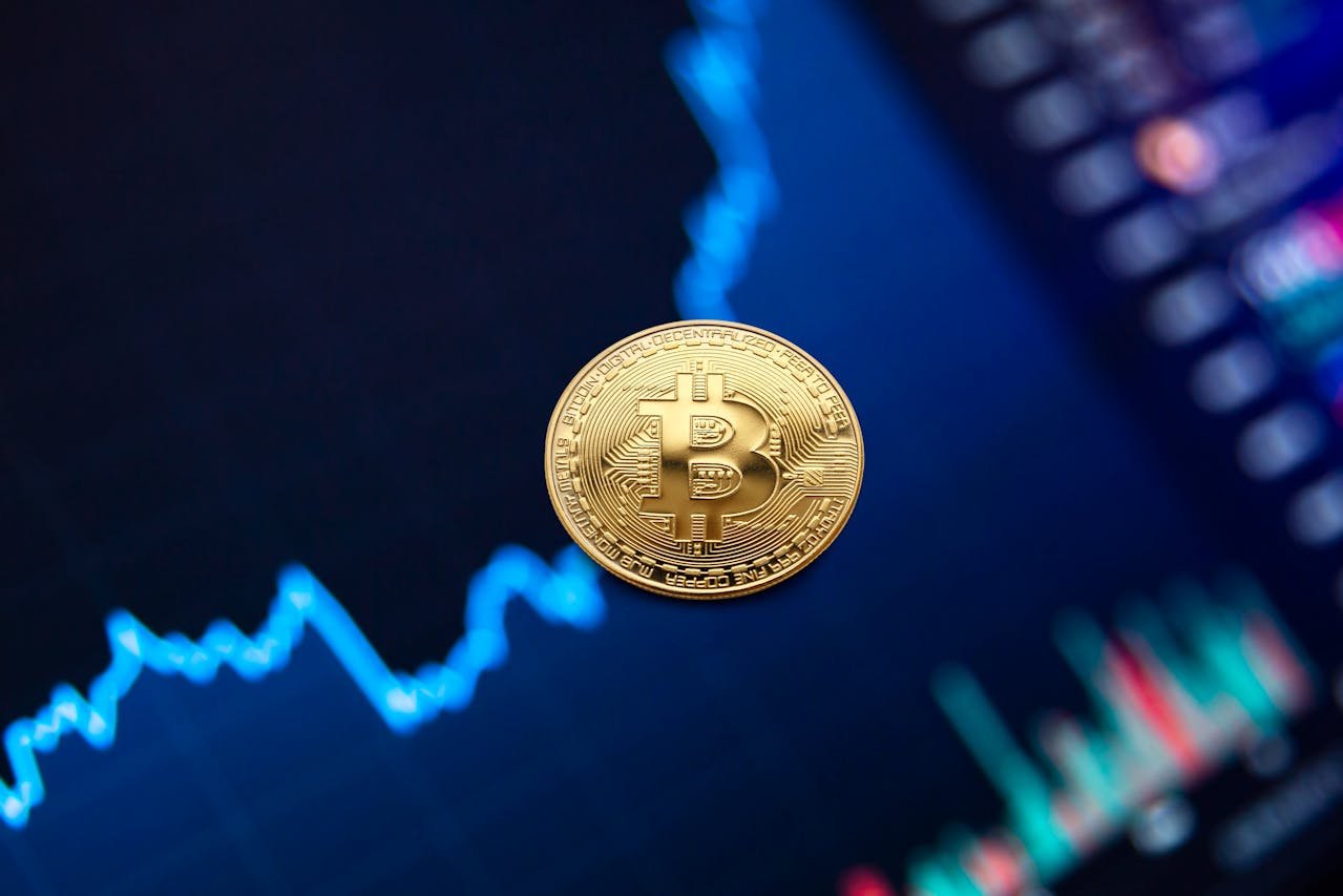 Golden Bitcoin coin floating above blue financial chart showing upward price trend