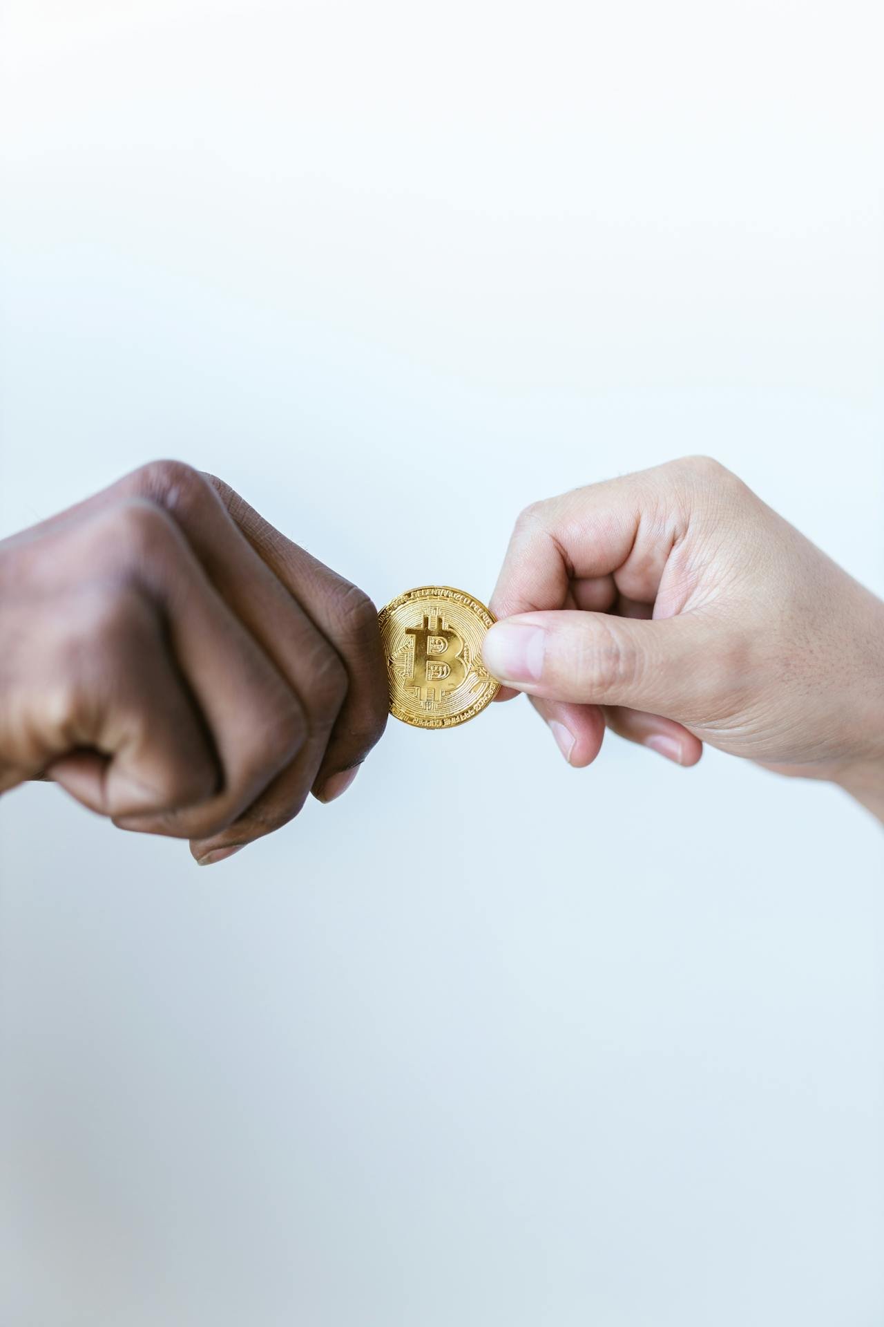 Hands exchanging Bitcoin
